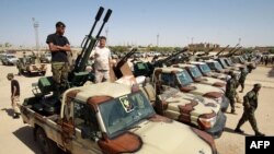 Members of the Libyan National Army gather in the city of Benghazi, on their way to reportedly back up fellow LNA fighters on the frontline west of Sirte, facing forces loyal to the UN-recognized Government of National Accord, on June 18, 2020. 