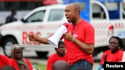 Chidi Odinkalu, chairman of Nigeria's National Human Rights Commission, addresses a gathering of people at a speak-out session of a #BringBackOurGirls rally in Lagos, Nigeria, June 7, 2014. 