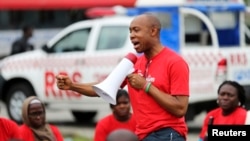 Chidi Odinkalu, then- chairman of Nigeria's National Human Rights Commission, addresses a gathering of people at a speak-out session of a #BringBackOurGirls rally in Lagos, Nigeria. Taken Jun. 7, 2014. 