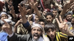 Anti-government protesters shout slogans during a rally to demand the ouster of Yemen's President Ali Abdullah Saleh outside Sana'a University, April 1, 2011