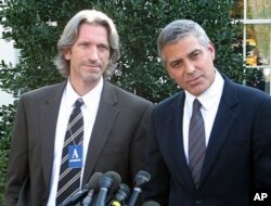 Actor, activist George Clooney (R) with activist John Prendergast