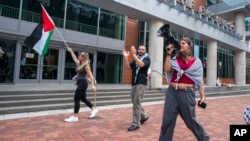 Alia Amanpour Trapp, right, leads the crowd during a pro-Palestine rally and march on Temple University campus in Philadelphia, Aug. 29, 2024.