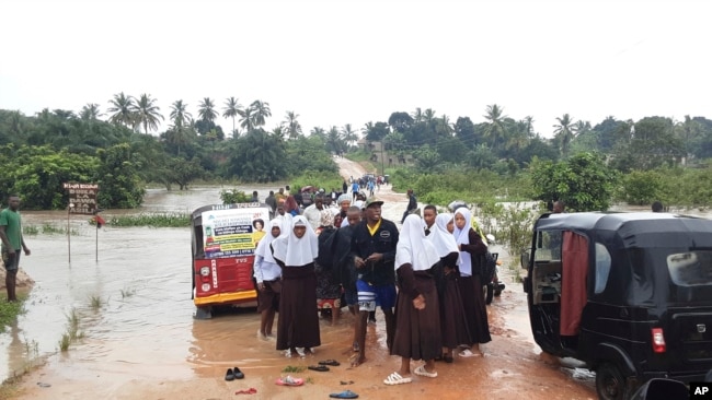 Schoolchildren are stranded on a damaged River Zingiziwa bridge in Dar Esalaam, Tanzania, on April 25, 2024. Flooding in Tanzania caused by weeks of heavy rain has killed at least 150 people as of May 4, 2024, and affected hundreds of thousands more.