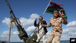 FILE - Libyan militias from towns throughout the country's west parade through Tripoli, Libya, Feb. 14, 2012.