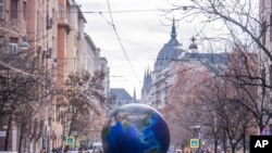 FILE - Activists demonstrate to demand measures against climate change, in Budapest, Hungary, Nov. 29, 2019. 