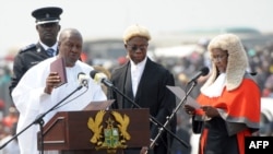 Ghanaian President John Mahama is sworn-in by Chief Justice Georgina Wood (R) at Independence Square, Accra, January 7, 2013. 