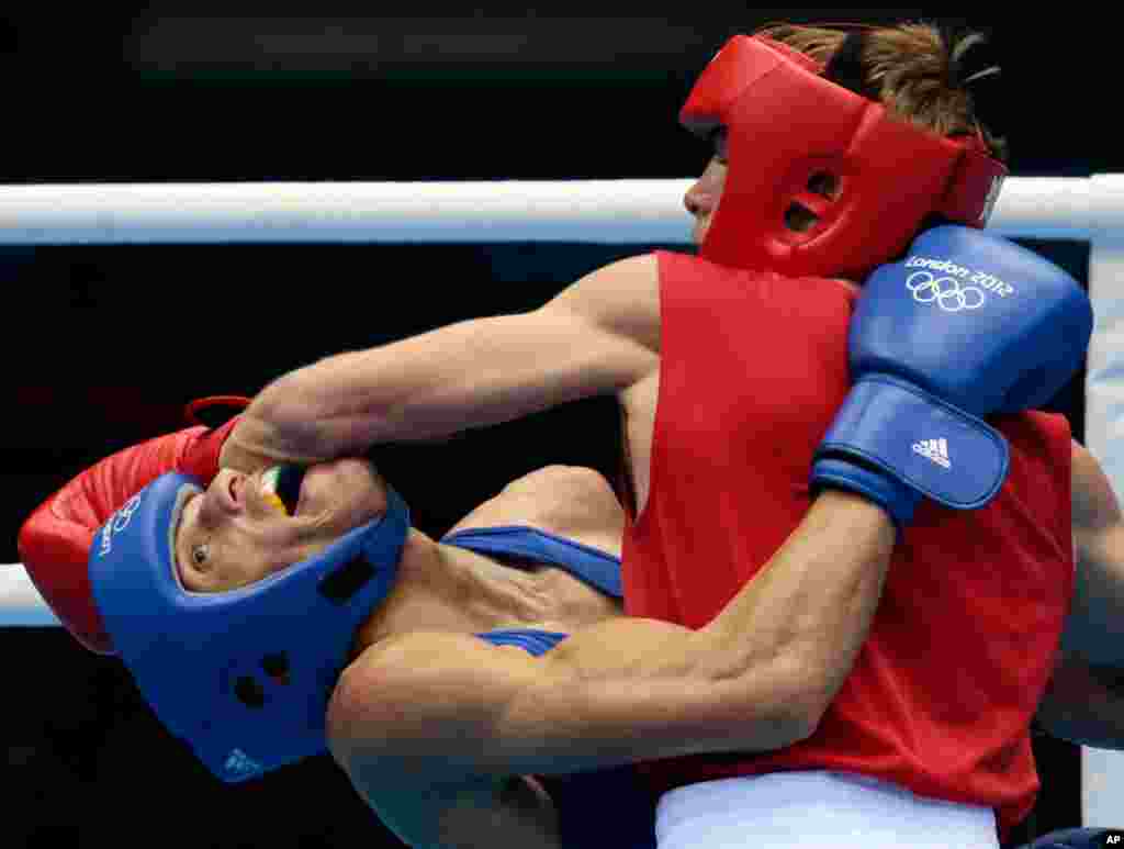 Russia's Sergey Vodopiyanov, right, fights Brazil's Robenilson Vieira de Jesus, during their men's bantam 56-kg boxing match.