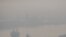 FILE - A cargo ship is seen through pollution along the Chao Phraya river in Bangkok, Thailand, Jan. 11, 2019.