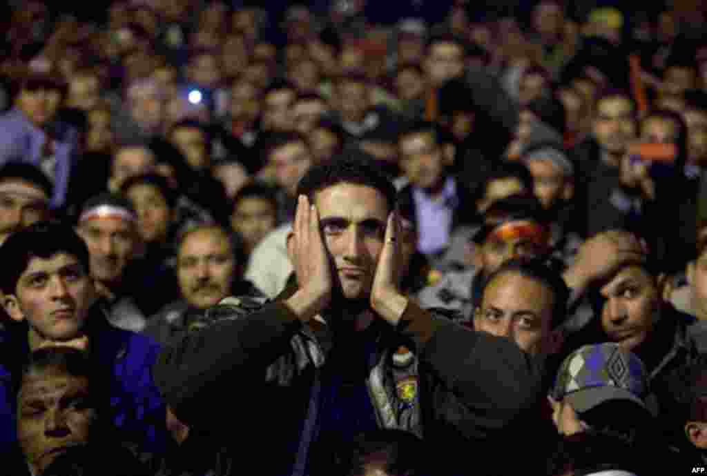 Anti-government protesters watch on a big screen as Egyptian President Mubarak makes a televised statement to his nation in Tahrir Square in downtown Cairo, Egypt Thursday, Feb. 10. (AP Photo/Emilio Morenatti)