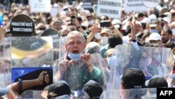 Lawyers shout slogans outside the city's main courthouse during a protest, as the heads of Turkish lawyers' associations wait for a second day to enter the parliament, in Ankara, Turkey, July 3, 2020. 