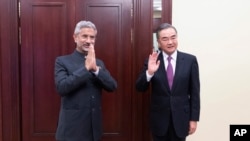 India's External Affairs Minister Subrahmanyam Jaishankar, left, and Chinese Foreign Minister Wang Yi 