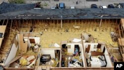 Damaged apartments are open up to the air at the Westbrooke Village Apartments in Trotwood, Ohio, after the roof was torn off from a severe storm the night before, May 28, 2019. 