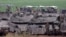 Israeli army troops stand around their tanks in an area along the border with the Gaza Strip in southern Israel on April 10, 2024, amid the ongoing conflict in the Palestinian territory between Israel and the militant group Hamas. (Photo by JACK GUEZ / AF