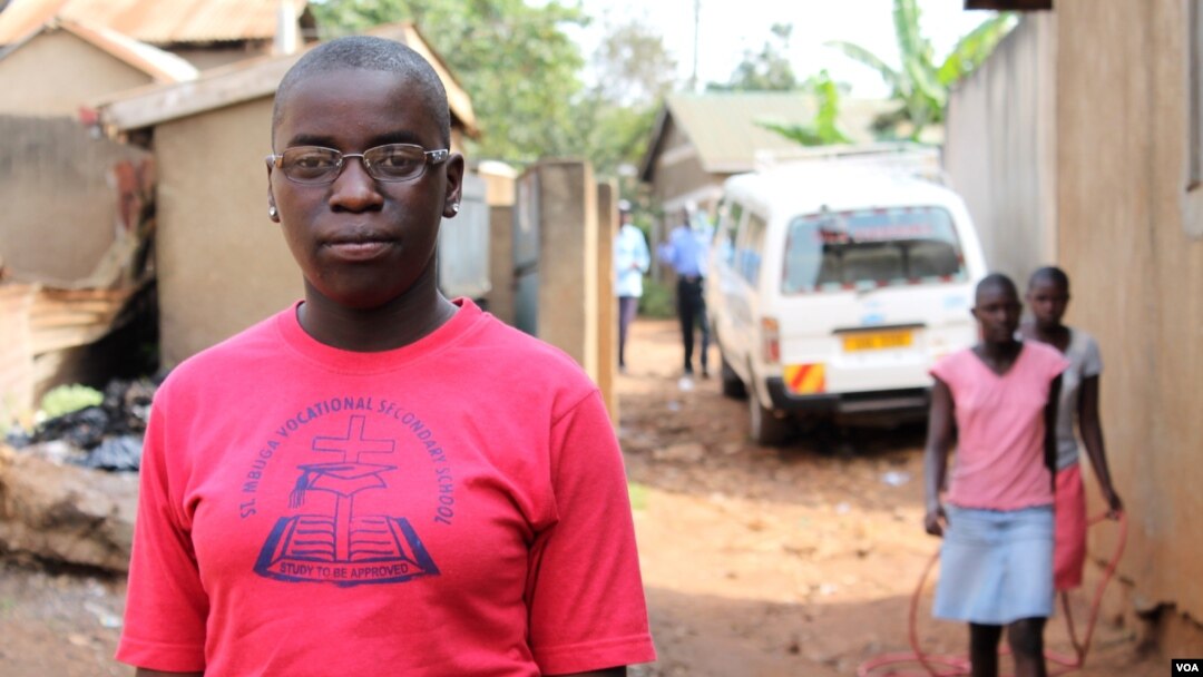 FILE - Phiona Mutesi stands near where she grew up in Katwe, Kampala, Uganda, Jan. 28, 2012. (H. Heuler/VOA)