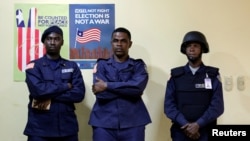 FILE - Police officers stand guard at National Election Commission headquarters in Monrovia, Liberia, Oct. 11, 2017. 