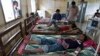 FILE - Patients with malaria areg treated at the hospital in Pailin, Cambodia, Aug. 26, 2009.