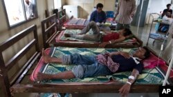 This Aug. 26, 2009 photo shows patients suffering from malaria being treated at the hospital in Pailin, Cambodia. 