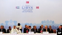 Fatih Mohammed Baja (L), Advisor of Political Affairs to Head of National Transitional Council of Libya, Khalid Al Ghaith (2nd L), United Arab Emirates (UAE) Assistant Minister for the Department of Economic Affairs, Turkish Foreign Minister Ahmet Davutog