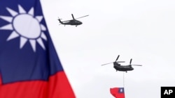 Helicopters fly over President Office with Taiwan National flag during the National Day celebrations in Taipei, Taiwan, Oct. 10, 2020.