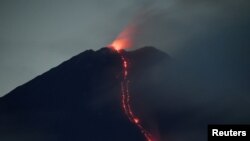 Mount Semeru volcano spews hot lava as it erupts, as seen from Oro-oro Ombo village in Lumajang, East Java province, Indonesia. (Credit:&nbsp;Antara Foto)