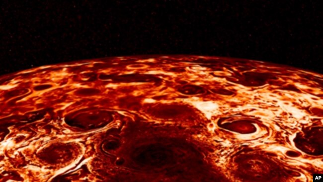This composite image provided by NASA, derived from data collected by the Jupiter-orbiting Juno spacecraft, shows the central cyclone at the planet's north pole and the eight cyclones that encircle it. (NASA/JPL-Caltech/SwRI/ASI/INAF/JIRAM via AP)
