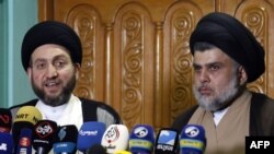 Iraqi Shiite Muslim leader and head of Hikma party Ammar al-Hakim (L) and Shiite cleric Moqtada Sadr speak to the media during a meeting in the Iraqi holy city of Najaf on May 17, 2018.