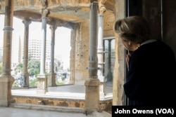 Evelyne Kozah looks out from the building. She is wife of the late Fouad Kozah, who extended the building in 1932.