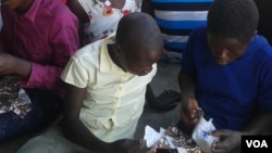 Some girls seen sewing re-usable sanitary pads in Zimbabwe. (Photo: VOA)