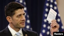 US Speaker of the House Paul Ryan (R-WI) displays a copy of the US Constitution while delivering a speech on "the state of American politics" to interns on Capitol Hill in Washington, March 23, 2016. 