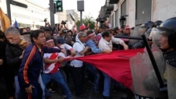 Manifestantes antigubernamentales se enfrentan a policías antidisturbios cerca del palacio de gobierno en Lima, Perú, el 5 de noviembre de 2022. 