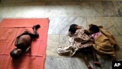 HIV-positive Arun, 3, left, HIV positive-Gopika, 2, center, and reportedly HIV-positive Subiksha, 4 months old, lie at the Community Health Education Society orphanage in Chennai, India. (file photo)