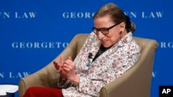 FILE - Supreme Court Justice Ruth Bader Ginsburg smiles as she answers questions from first-year students at Georgetown Law, Sept. 26, 2018, in Washington. 