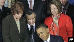 President Barack Obama signs the Don't Ask, Don't Tell Repeal Act of 2010 with, from left, Commander Zoe Dunning, Marine Staff Sgt. Eric Alva, and House Speaker Nancy Pelosi of Calif., at the Interior Department in Washington, Dec 22, 2010