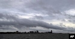 Clouds and rain form over downtown Corpus Christi, Texas, as the outer bands of Hurricane Harvey move closer to shore, Aug. 25, 2017.
