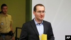 Defendant Markus R. (no full name given due to German law), a former employee of Germany's foreign intelligence agency, BND, arrives for his trial for espionage in a courtroom in Munich, Germany, Monday, Nov. 16, 2015.