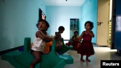 Baby girls play inside the Life Line Trust orphanage in Salem in the southern Indian state of Tamil Nadu, June 20, 2013.