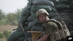 A U.S. Marine Scout-Sniper, pictured during a lull in an exchange of fire with Taliban militants, in Helmand province, southern Afghanistan, August 27, 2011.