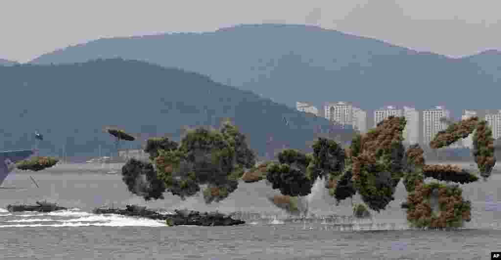 South Korean landing craft make their way to hit shores through smoke screens during a ceremony to mark the 1950 Incheon landing operations in waters off Incheon.