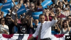 President Barack Obama waves to the crowd as he arrives to speak at a campaign event, Nov. 1, 2012, at the Cheyenne Sports Complex in Las Vegas.