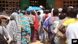 People stand in line to cast their ballots, during elections in Bangui, Central African Republic, Wednesday, Dec. 30, 2015. 