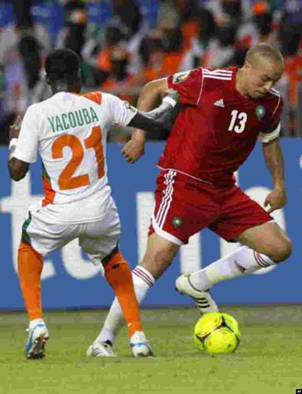 Morocco's Houssine Kharja (13) dribbles the ball against Niger's Seydou Ali Yacouba (21) during their final African Cup of Nations Group C soccer at the Stade De L'Amitie Stadium in Libreville, Gabon January 31, 2012.