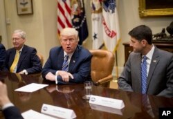 FILE - President Donald Trump, with Senate Majority Leader Mitch McConnell of Kentucky, left, and House Speaker Paul Ryan of Wisconsin, speaks during a meeting with congressional leaders in the Roosevelt Room of the White House in Washington, June 6, 2017