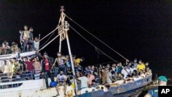 Kapal penangkap ikan bermuatan para migran berlabuh di pelabuhan pulau Lampedusa Sisilia, Italia selatan, Senin malam, 27 September 2021. (Sea-Watch.org/David Lohmueller via AP)