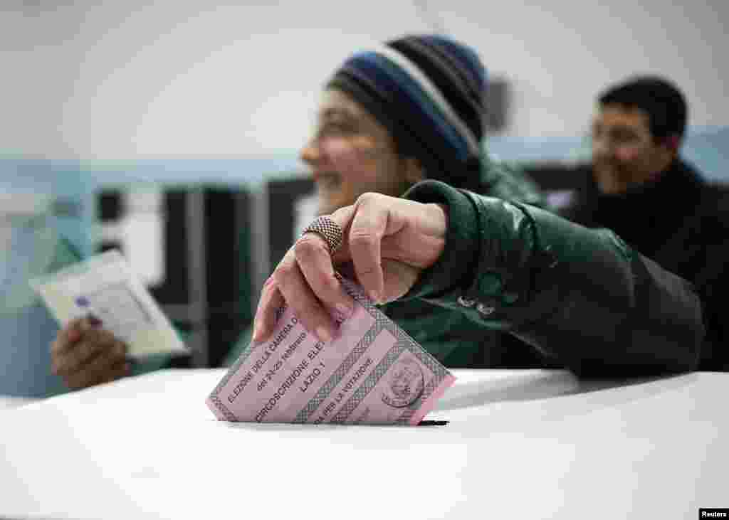 A woman casts her vote in a polling station in Rome, Feb. 24, 2013.