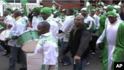 Nigerian fans parade through the Hillsborough neighborhood of Johannesburg before their team's first game in the World Cup tournament.
