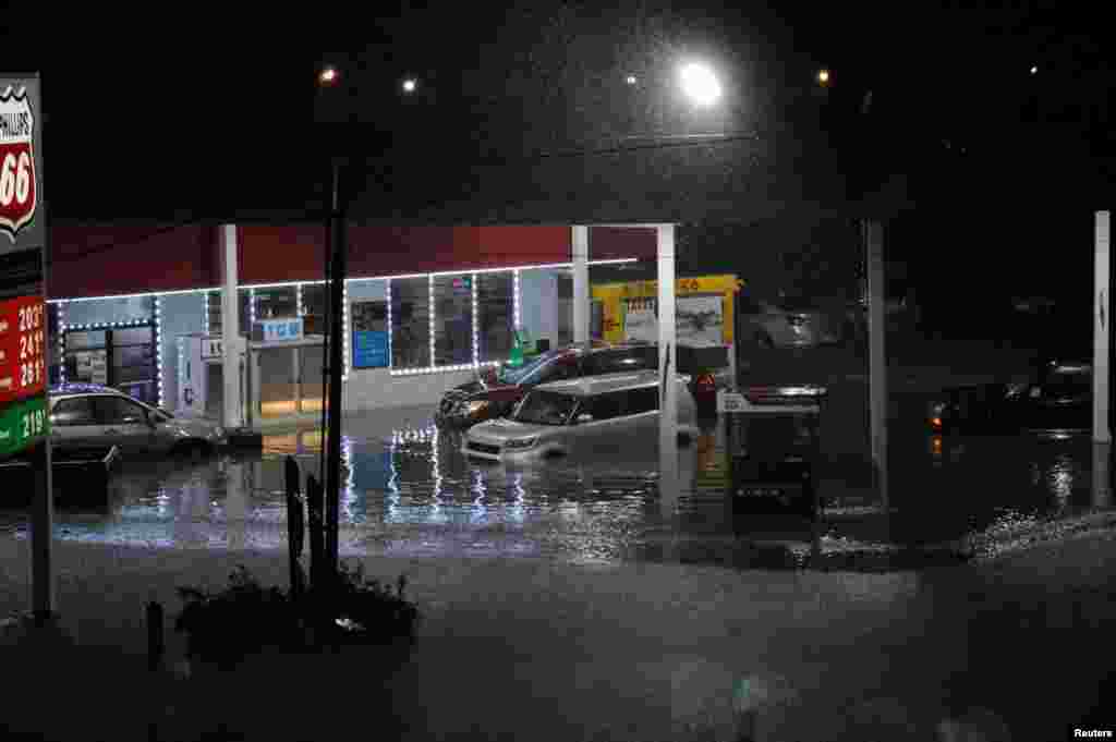 Cars sit abandoned at a flooded gas station after Hurricane Harvey made landfall on the Texas Gulf coast and brought heavy rain to the region, in Houston, Aug. 26, 2017.