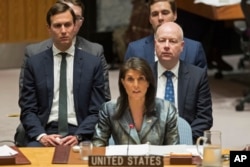 FILE - Jared Kushner, left, and Jason Greenblatt, right, listen as American Ambassador to the United Nations Nikki Haley speaks during a Security Council meeting on the situation in Palestine at United Nations headquarters, Feb. 20, 2018.