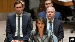 FILE - Jared Kushner, left, and Jason Greenblatt, right, listen as American Ambassador to the United Nations Nikki Haley speaks during a Security Council meeting on the situation in Palestine at United Nations headquarters, Feb. 20, 2018.