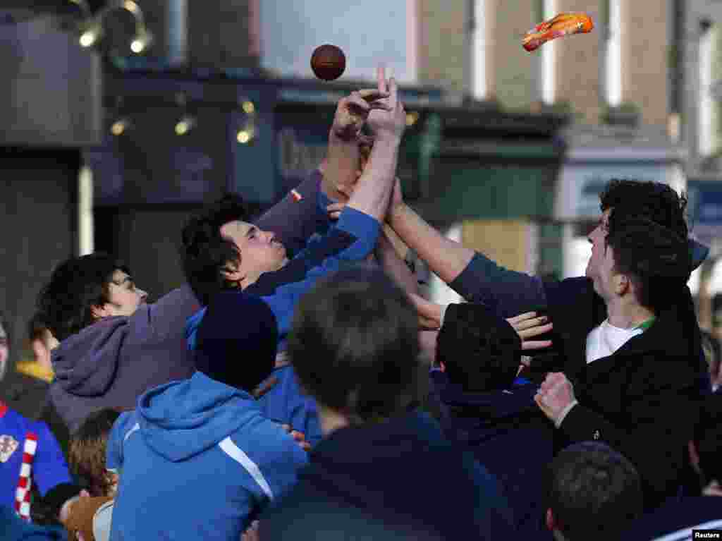 Men jump to catch a leather ball at the start of the annual &#39;Fastern Eve Handba&#39; event in Jedburgh, Scotland. Known locally as Jethart Ba&rsquo;, the handball games are played on the Thursday after Shrove Tuesday, and involves two teams getting the ribboned leather ball to either the top or bottom of the town, with no rules.
