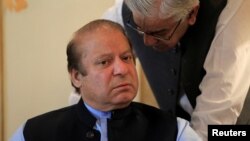 Former Pakistani Prime Minister Nawaz Sharif speaks with an official during a meeting in Islamabad, Aug. 9, 2017. 